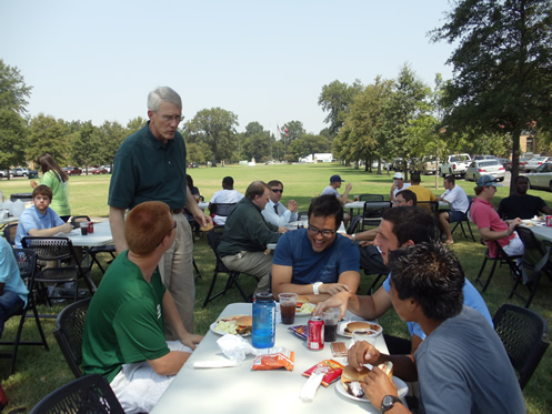 Dr. Clint Wood, chair of the Division of Accountancy, CIS, and Finance talks with students as they enjoy lunch at the Welcome Back Picnic.